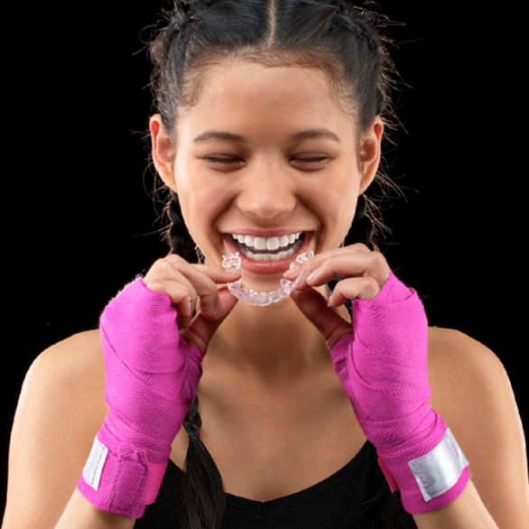 Teen wearing clear aligners during daily activities