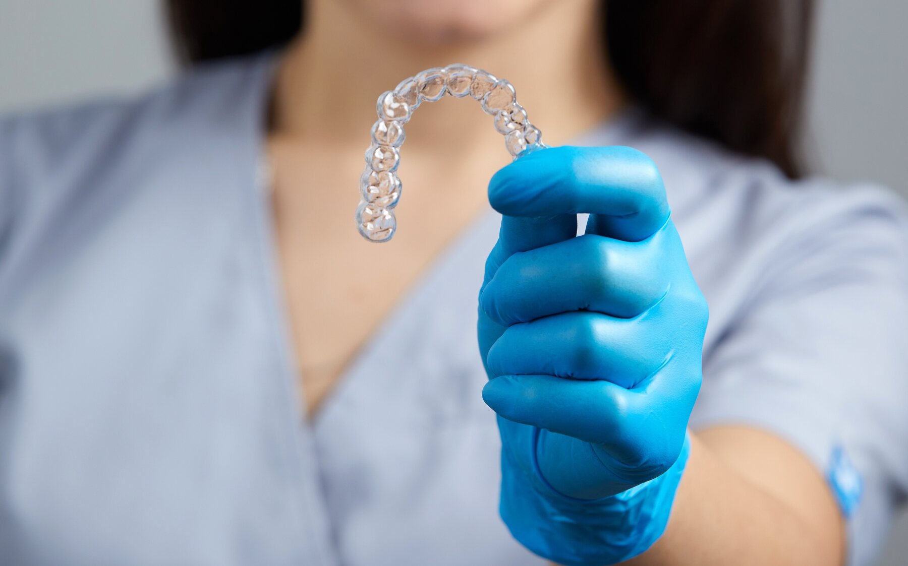 Orthodontist holding a complete clear aligner